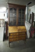 AN EARLY TWENTIETH CENTURY BUREAU BOOKCASE, THE GLAZED TWO DOOR TOP ENCLOSING TWO SHELVES, THE