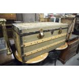 A WOODEN AND LEATHERETTE COVERED TRAVELLING TRUNK