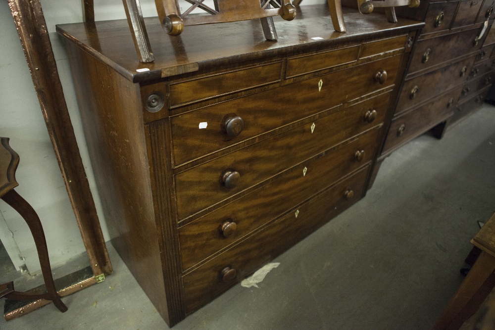 AN EARLY VICTORIAN MAHOGANY CHEST WITH THREE SHALLOW FRIEZE DRAWERS, OVER FOUR GRADUATED LONG