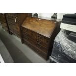 GEORGE III MAHOGANY BUREAU, WITH SLOPING FALL FRONT OVER TWO SHORT AND THREE GRADUATED LONG
