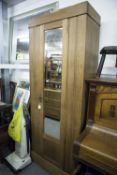 AN OAK WARDROBE WITH MIRROR DOOR, 2'6" WIDE