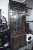 A LATE GEORGIAN MAHOGANY SMALL CUPBOARD WITH ASSOCIATED ASTRAGAL GLAZED BOOKCASE