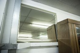 A LARGE RECTANGULAR BEVELLED EDGE MIRROR IN SILVER WOODEN FRAME
