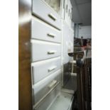 AN EARLY TWENTIETH CENTURY KITCHEN LARGER CUPBOARD, A DROP LEAF TABLE AND TALL CHEST OF DRAWERS,