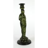 GREEN GLAZED POTTERY CANDLESTICK modelled as a classical female figure, on a circular base, 12 1/