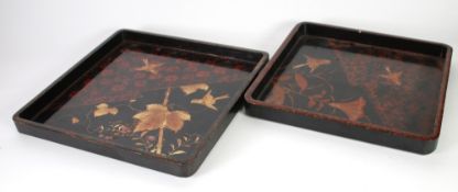 NESTING PAIR OF JAPANESE BLACK LACQUERED TRAYS of square form, decorated with birds in flight,