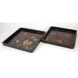 NESTING PAIR OF JAPANESE BLACK LACQUERED TRAYS of square form, decorated with birds in flight,