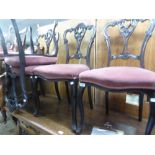 A SET OF FOUR LATE VICTORIAN DARK MAHOGANY DRAWING ROOM SINGLE CHAIRS WITH HEAVILY CARVED BACKS