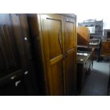 A MID TWENTIETH CENTURY OAK DOUBLE WARDROBE, TWO PANEL SOLID DOORS WITH CARVED DECORATION, ON SHAPED