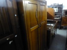 A MID TWENTIETH CENTURY OAK DOUBLE WARDROBE, TWO PANEL SOLID DOORS WITH CARVED DECORATION, ON SHAPED