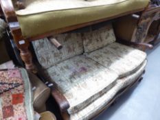 A CARVED MAHOGANY FRAMED BERGERE TWO SEATER SETTEE WITH SINGLE CANE PANELS, ON CLAW AND BALL FEET (