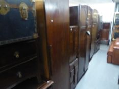A PAIR OF ART DECO OAK BEDSIDE TABLES OF FOUR GRADUATED DRAWERS AND A MATCHING WARDROBE (3)