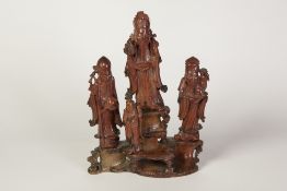 CHINESE CARVED SOAPSTONE GROUP, modelled as four immortals standing on rockwork, 10 1/2" (26.7cm)