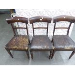 A SET OF THREE EARLY NINETEENTH CENTURY MAHOGANY DINING CHAIRS, WITH CURVED SHOULDER BOARDS, ON