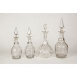 NINE CUT GLASS DECANTERS, WITH STOPPERS, including; A PART SUITE OF FIVE (one with matched