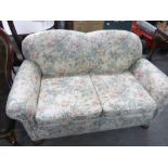 A TWO SEATER DROP-ARM SOFA, SHAPED BACK, SCROLL ARMS, BUN MAHOGANY SUPPORTS, UPHOLSTERED