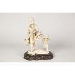 JAPANESE MEIJI PERIOD CARVED SECTION IVORY GROUP of a street vendor carrying numerous wares, child
