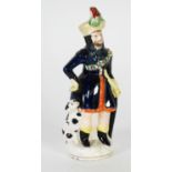 19th CENTURY STAFFORDSHIRE POTTERY GROUP, modelled as a huntsman with a dog at his side, on a gilt