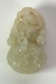 A CHINESE QING DYNASTY PALE CELADON JADE CARVING OF A DOUBLE GOURD entwined with further gourd and