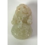 A CHINESE QING DYNASTY PALE CELADON JADE CARVING OF A DOUBLE GOURD entwined with further gourd and