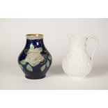 VICTORIAN EMBOSSED WHITE STONEWARE BALUSTER SHAPE JUG design of anthemions and fleur de lis 7 1/