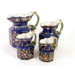 SET OF FOUR CIRCA 1830 STAFFORDSHIRE POTTERY OCTAGONAL JUGS, with 'dragon' handles, the royal blue