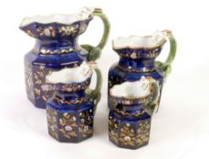 SET OF FOUR CIRCA 1830 STAFFORDSHIRE POTTERY OCTAGONAL JUGS, with 'dragon' handles, the royal blue