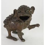 ORIENTAL PATINATED BRONZE MODEL OF A DOG OF FO modelled with front left paw raised, 6" (15.2cm)