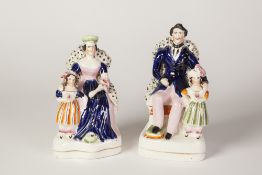A PAIR OF VICTORIAN STAFFORDSHIRE POTTERY MODELS OF QUEEN VICTORIA AND PRINCE ALBERT, she with