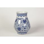 TWENTIETH CENTURY CHINESE BLUE AND WHITE PORCELAIN VASE, of footed baluster form, decorated with