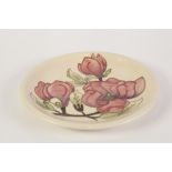 MODERN MOORCROFT TUBE LINED POTTERY PLAQUE PINK MAGNOLIA on a cream ground, impressed and green