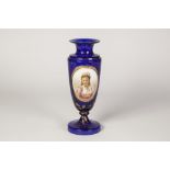 EARLY TWENTIETH CENTURY OVERLAID BLUE GLASS PEDESTAL VASE, of ovoid form with waisted neck, the gilt