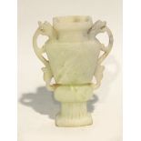 CHINESE CARVED PALE GREEN HARDSTONE TWO HANDLED VASE, of flattened archaic form, decorated with