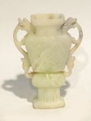 CHINESE CARVED PALE GREEN HARDSTONE TWO HANDLED VASE, of flattened archaic form, decorated with
