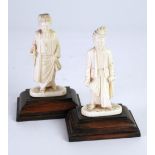 PAIR OF MALAYAN CARVED IVORY FIGURES OF MEN, both modelled standing in traditional robes and