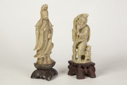 TWO CHINESE CARVED GREEN SOAPSTONE FIGURES, one modelled a Guan Yin, the other as a fisherman with a