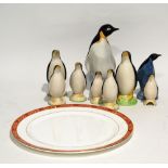 NINE POTTERY MODELS OF PENGUINS, including two Poole example, 8 3/4" (22.3cm) high and smaller,