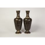 PAIR OF INDIAN BRASS AND BLACK LACQUERED BRASS VASES, each of oviform with circular base,