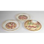 THREE BOXED PORCELAIN CABINET PLATES painted with fruit signed Ken Yates (3)