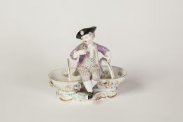 NINETEENTH CENTURY MEISSEN PORCELAIN FIGURAL RECEIVER, modelled as a well dressed boy with posy of