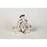 NINETEENTH CENTURY MEISSEN PORCELAIN FIGURAL RECEIVER, modelled as a well dressed boy with posy of