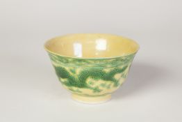 A SMALL CHINESE PORCELAIN BOWL , THE BODY INCISED AND ENAMELLED ON THE BISCUIT IN YELLOW AND