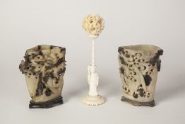 AN EARLY TWENTIETH CENTURY CHINESE CANTON CARVED IVORY CONCENTRIC BALL, supported on a figural