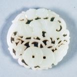 A CHINESE QING DYNASTY CIRCULAR WHITE JADE PENDANT carved and pierced with a stylized bat,