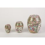 SET OF THREE LATE 19th CENTURY CHINESE CANTON DECORATED BARREL SHAPED COVERED JARS, autour with