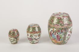 SET OF THREE LATE 19th CENTURY CHINESE CANTON DECORATED BARREL SHAPED COVERED JARS, autour with