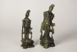 TWO LATE NINETEENTH/EARLY TWENTIETH CENTURY CHINESE GREEN SOAPSTONE FEMALE FIGURES, one holding a