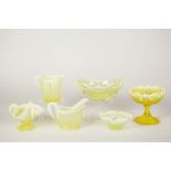 A SELECTION OF SIX PIECES OF VASELINE GLASS VIZ TWO JUGS, A STEM BOWL AN THREE OTHER HANDLED