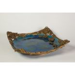LATE NINETEENTH CENTURY 'SEVRES' FRENCH POTTERY FOOTED DISH, with ornate gilt metal mount, the