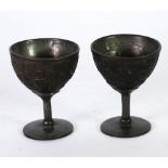 PAIR OF 18th/19th CENTURY CHINESE CARVED COCONUT SHELL AND PEWTER LINED STEMMED CUPS each with a 'V'